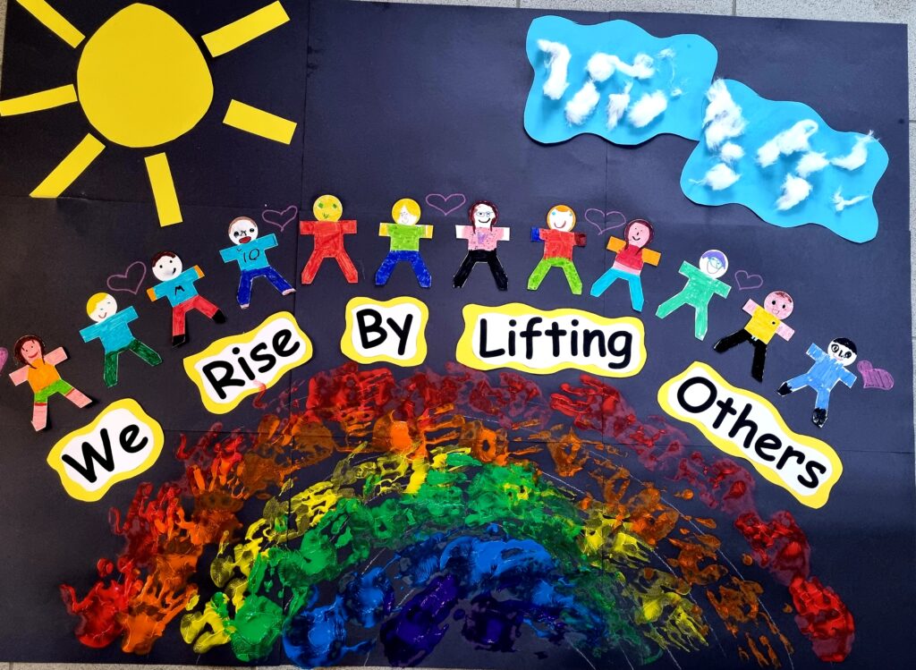 A cardboard with a collage of a rainbow and people