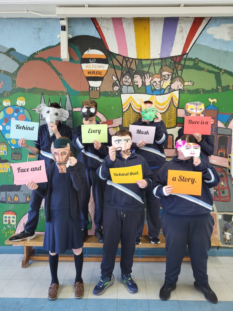 A group of children wearing animal masks and holding signs