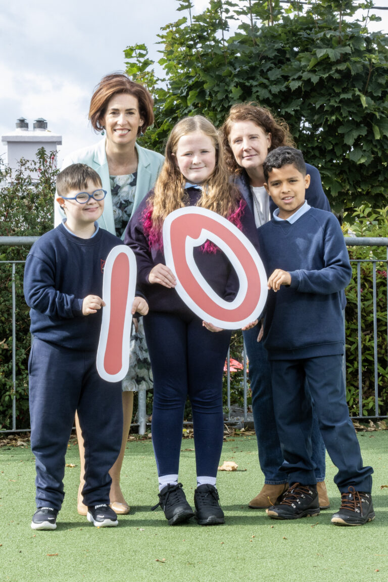 Minister Naughton with three primary school children and the director of the national disability authority.